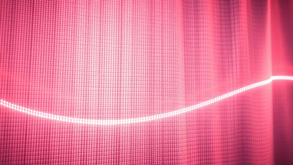 Close-up of LED light panel behind translucent fabric trade show graphic